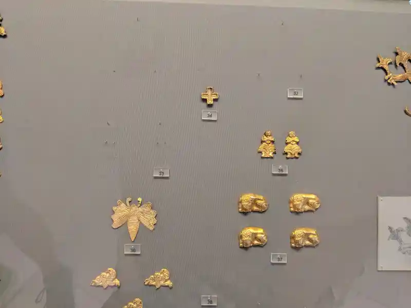 Gold cross-shaped ceremonial ornament